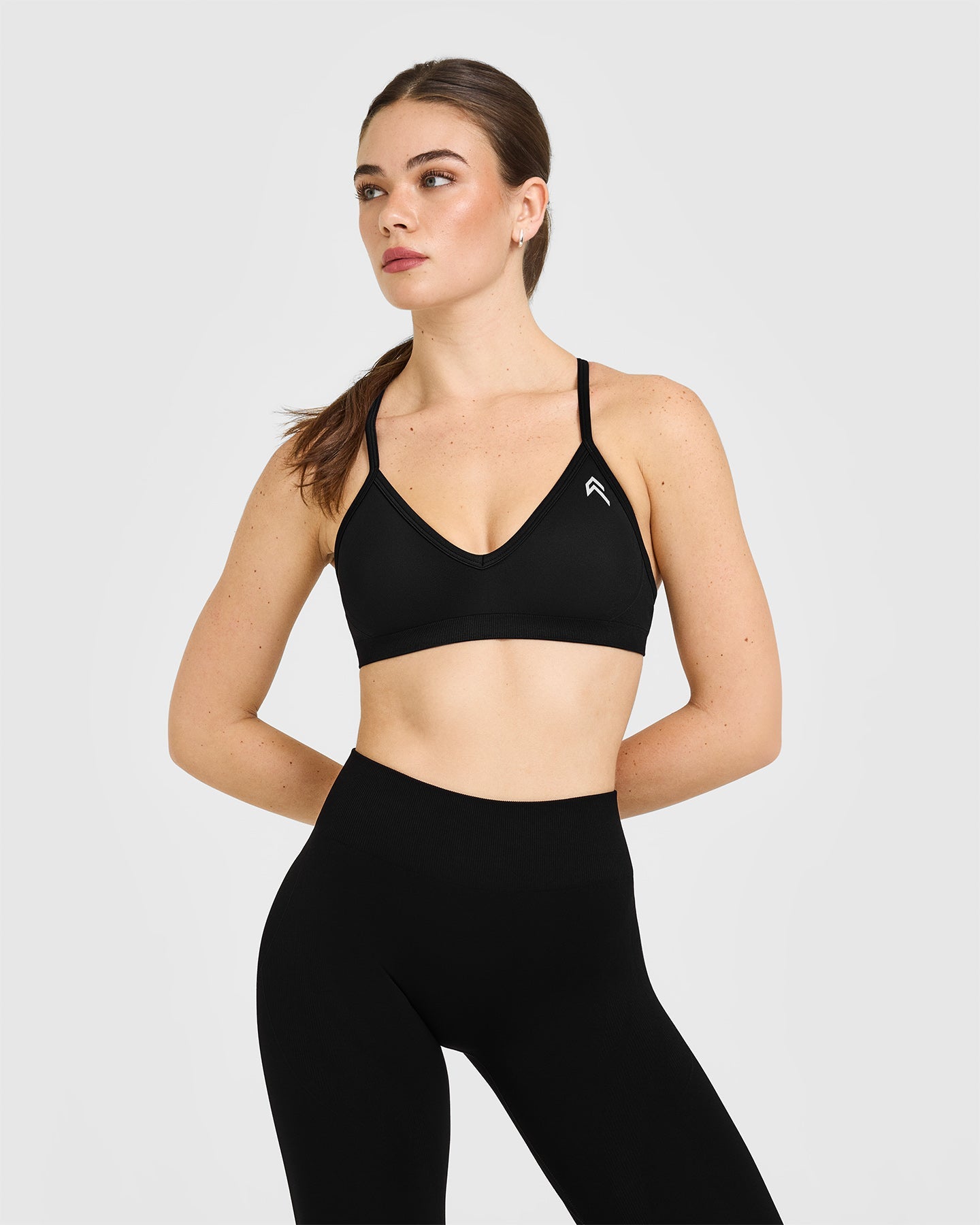 EnhanceLift Seamless Strappy Sports Bra with White Logo | Black