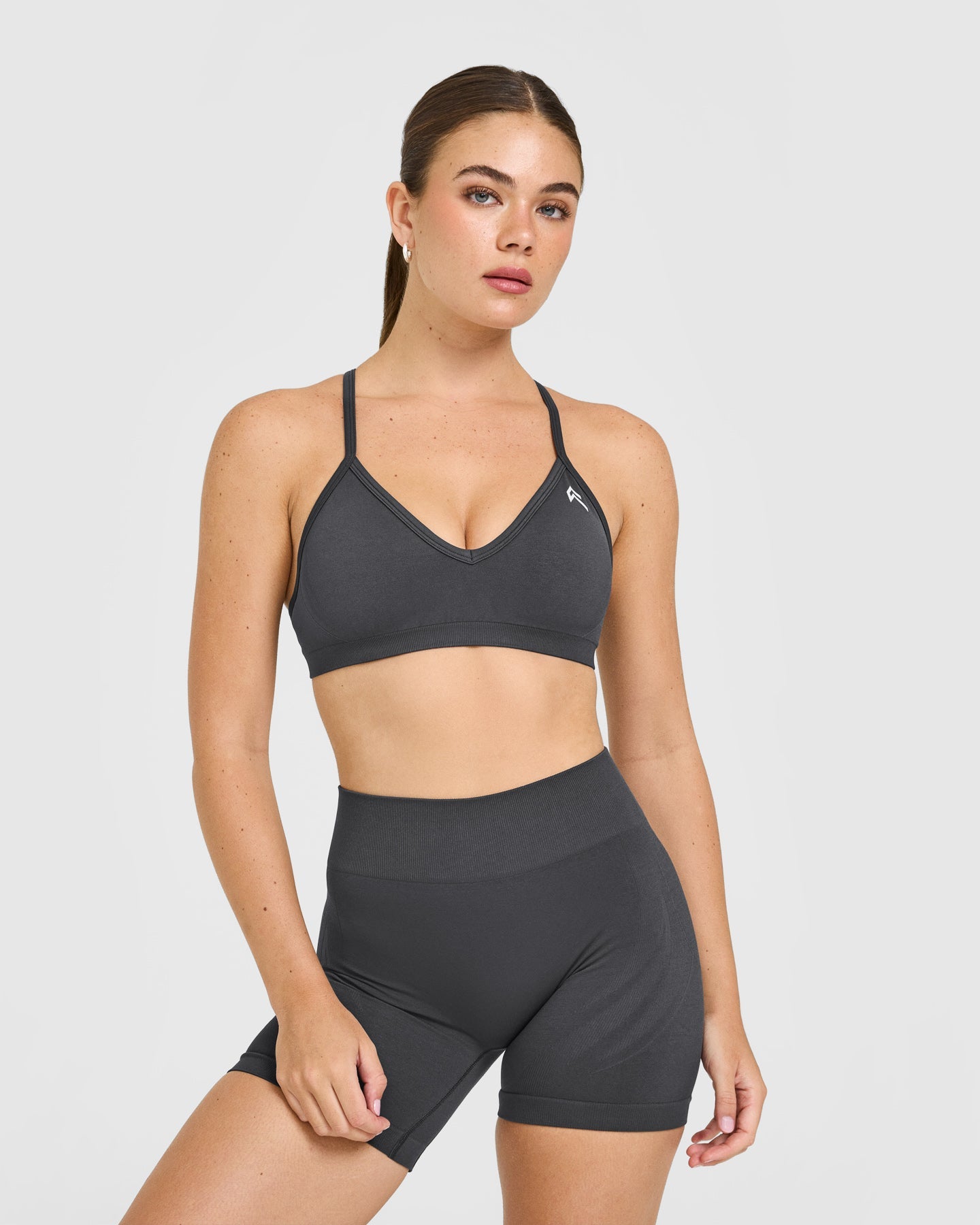 EnhanceLift Seamless Strappy Sports Bra with White Logo | Coal