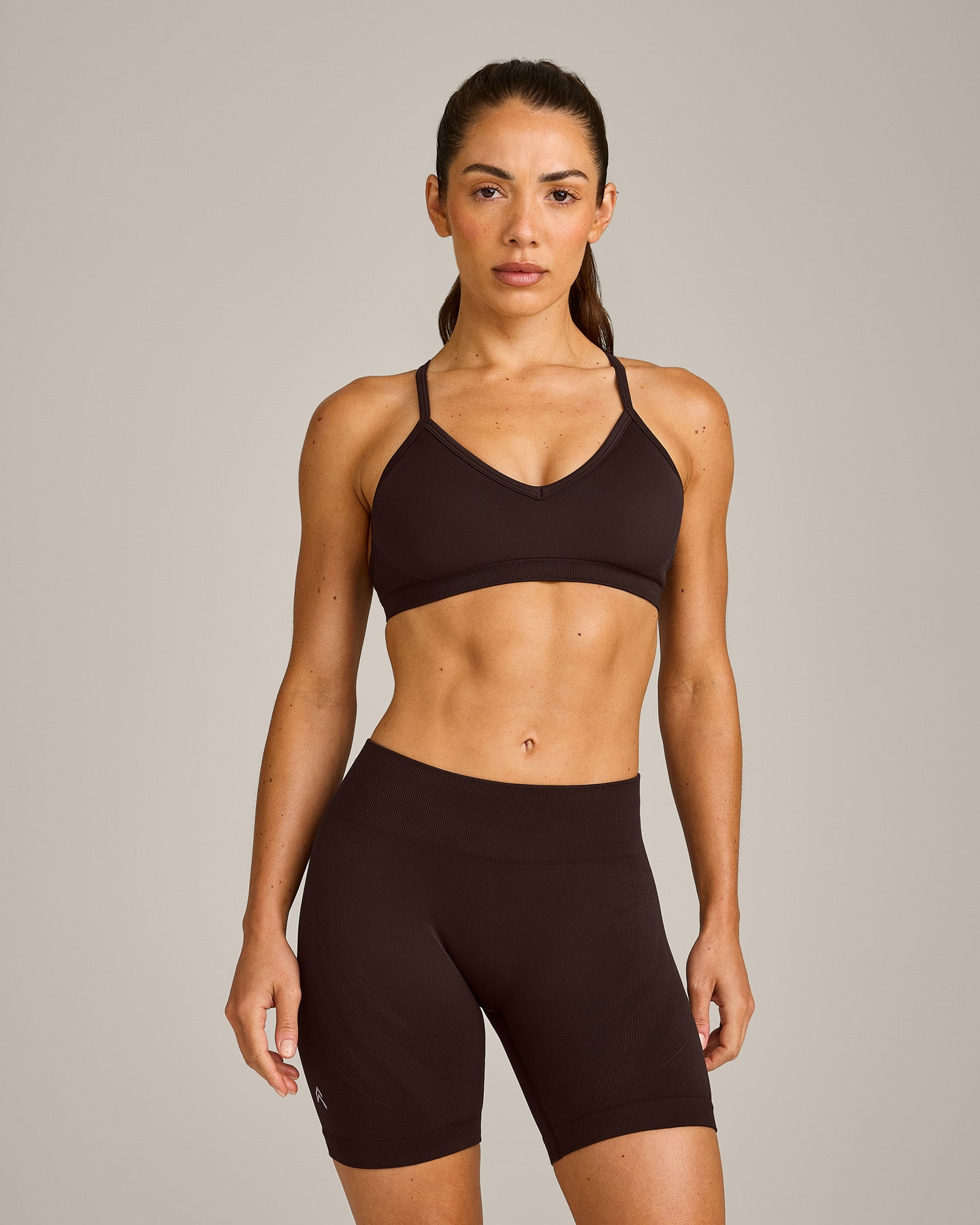 EnhanceLift Seamless Strappy Sports Bra with Grey Logo | 70% Cocoa