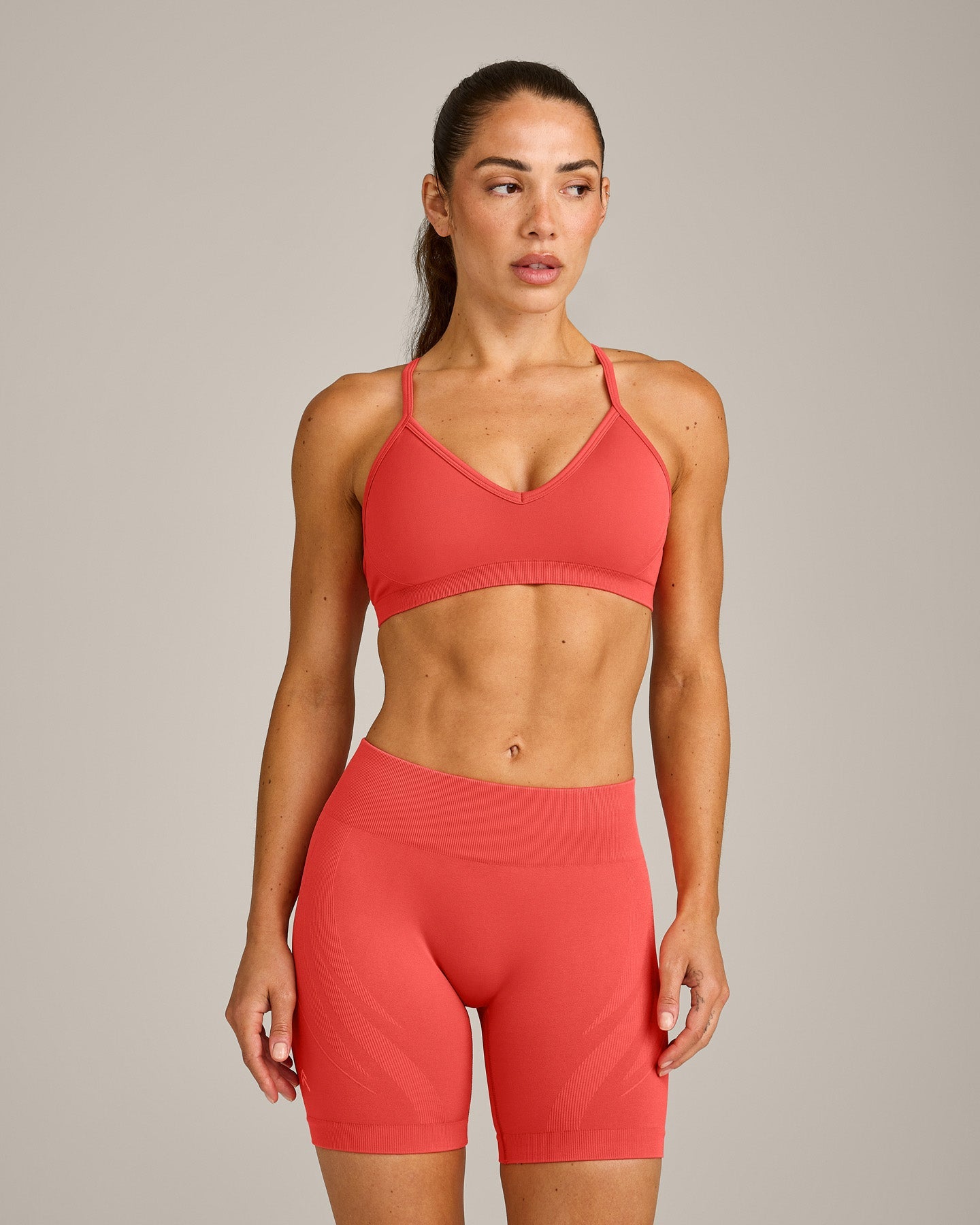 EnhanceLift Seamless Strappy Sports Bra with Grey Logo | Dark Charged Coral