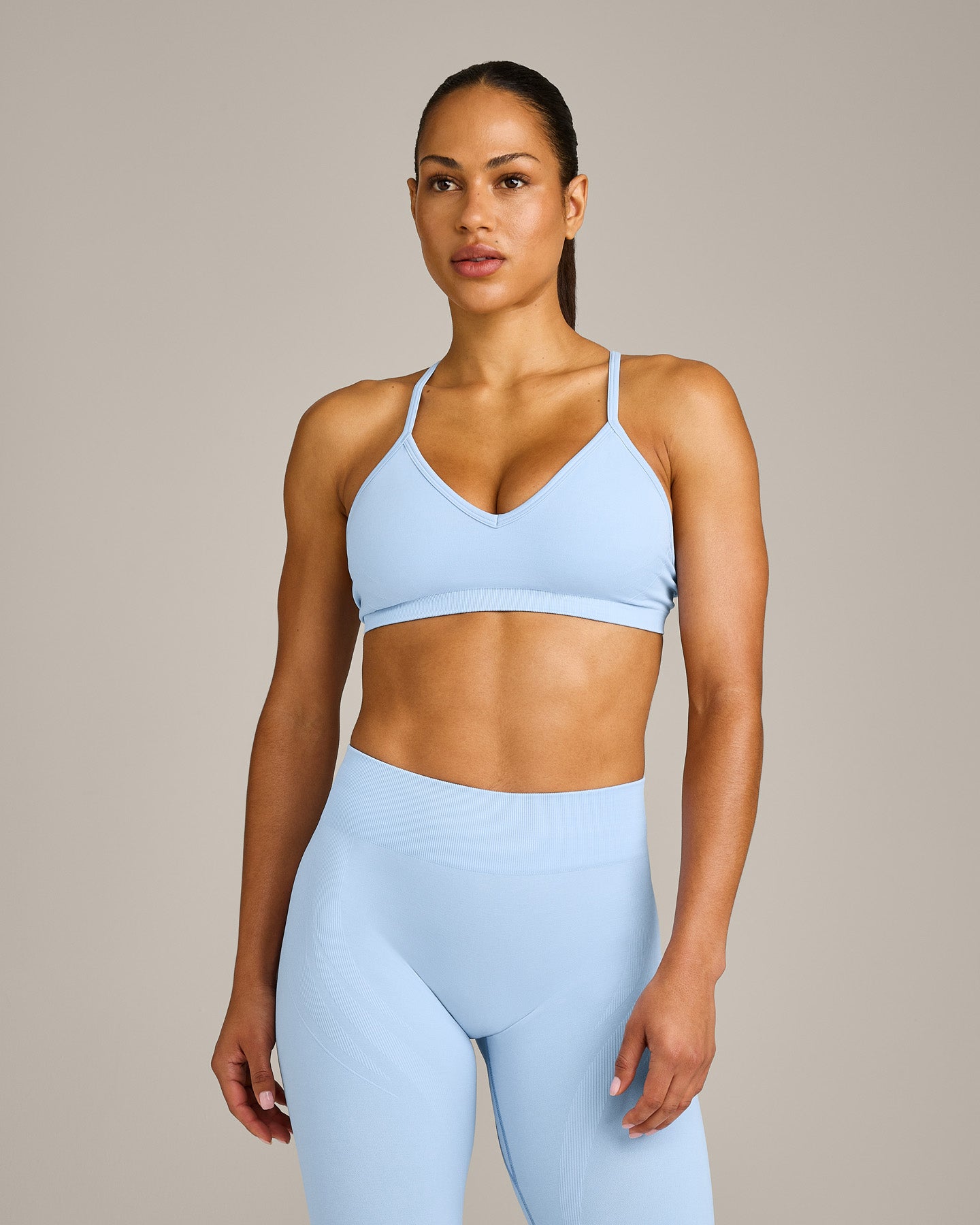 EnhanceLift Seamless Strappy Sports Bra with Grey Logo | Powdered Blue