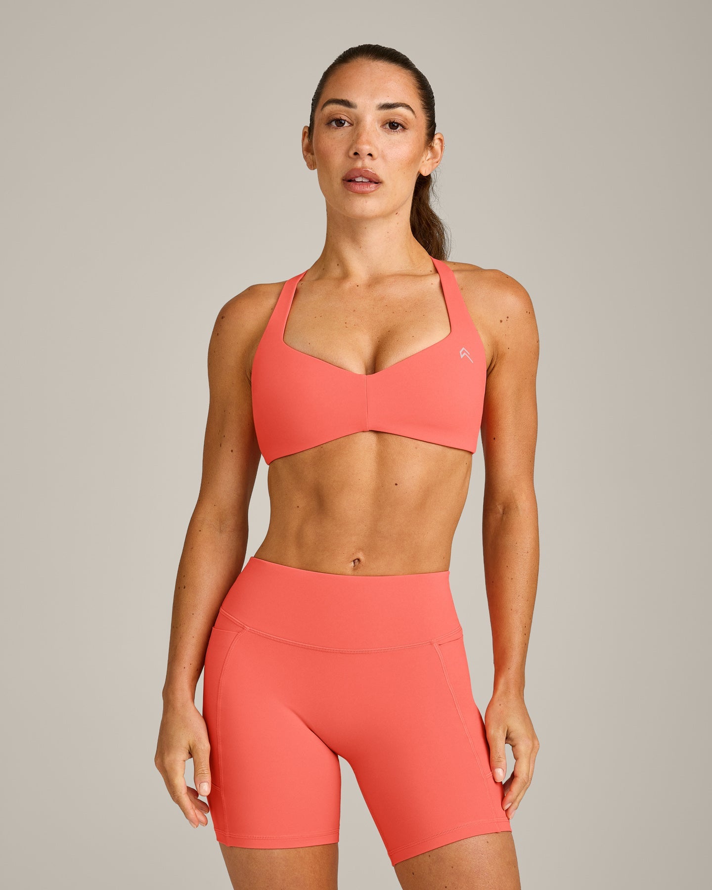 UnifiedMove T Back Minimal Bralette with Reflective Logo | Light Charged Coral